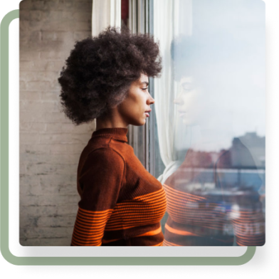 Side-view of a woman looking out of a window